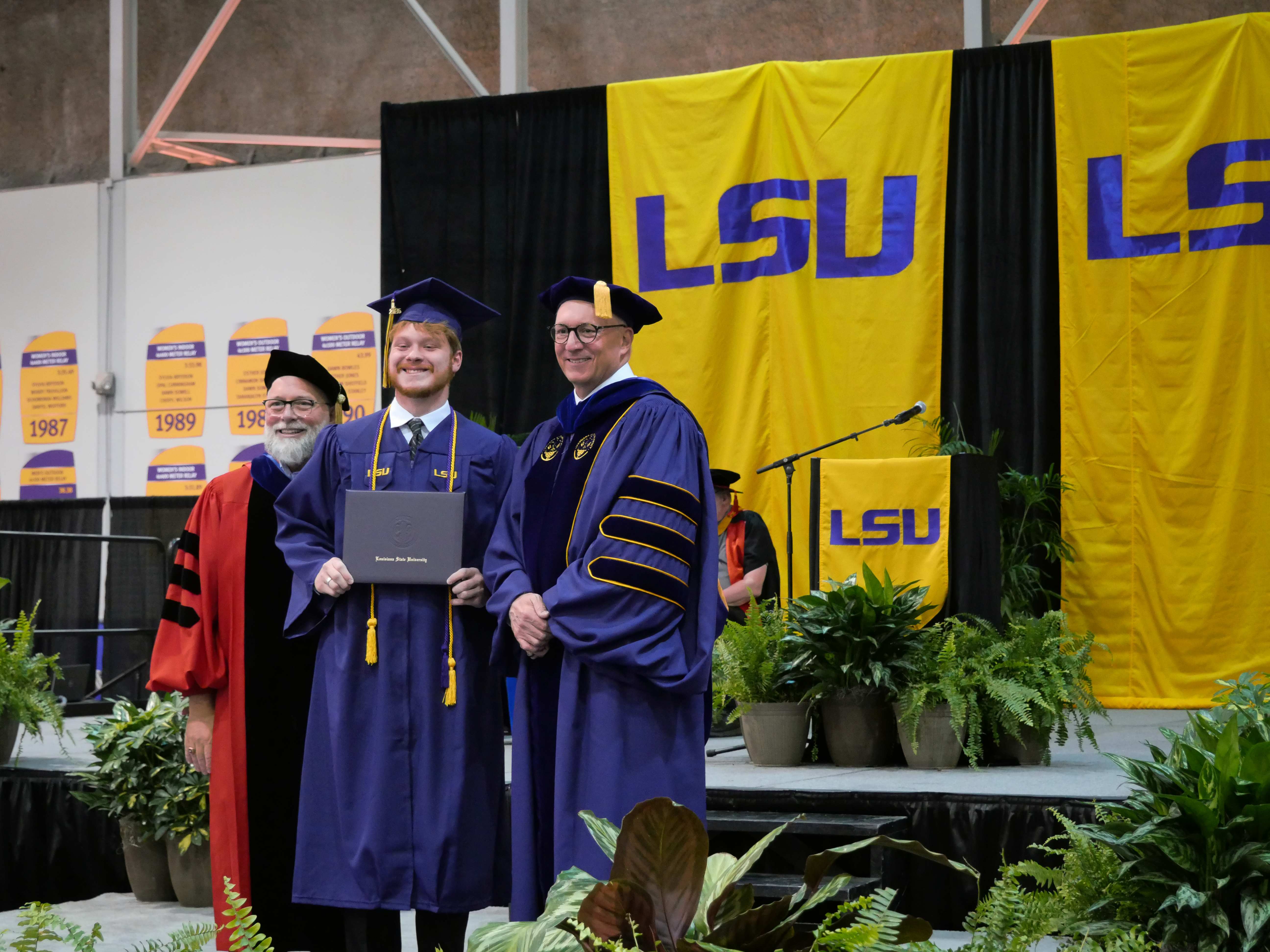 Grad receiving diploma on stage. 