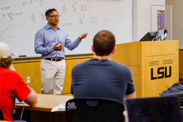 Professors teacher in front of white board