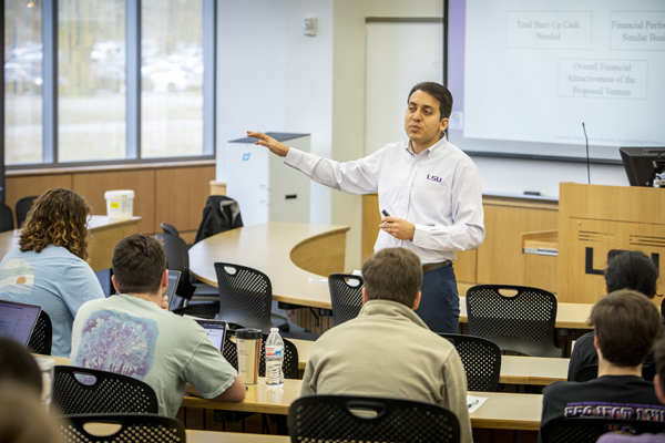 Professor lectures in front of students in classroom