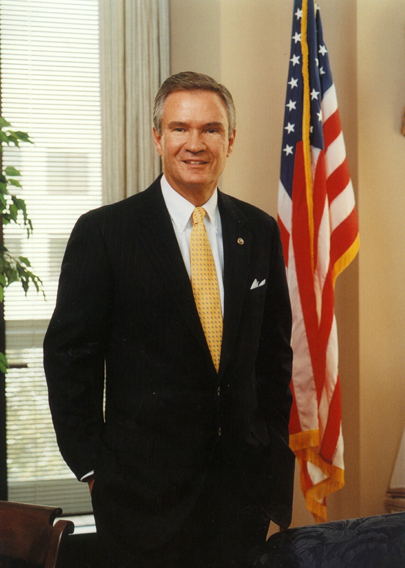 a man standing next to an American flag