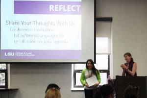 conference attendee receives certificate of completion while attendees applaud