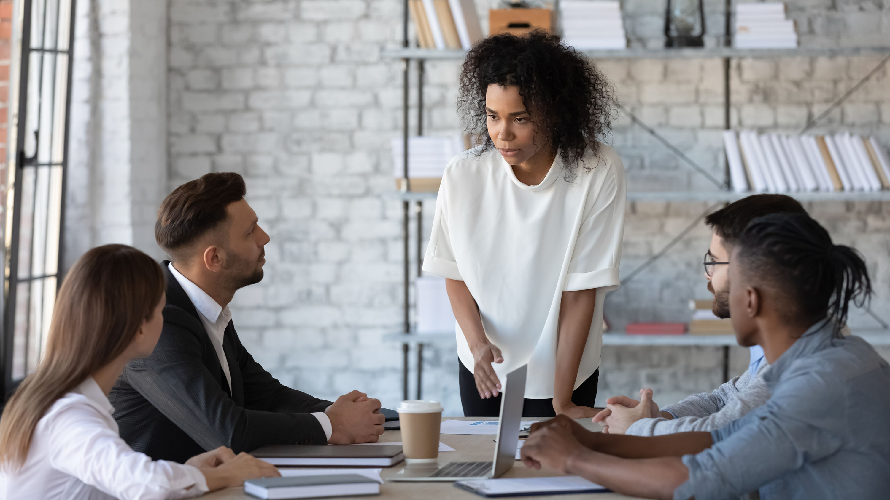 Black woman leading a team discussion