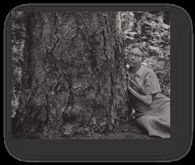 Caroline Dormon sitting by a tree