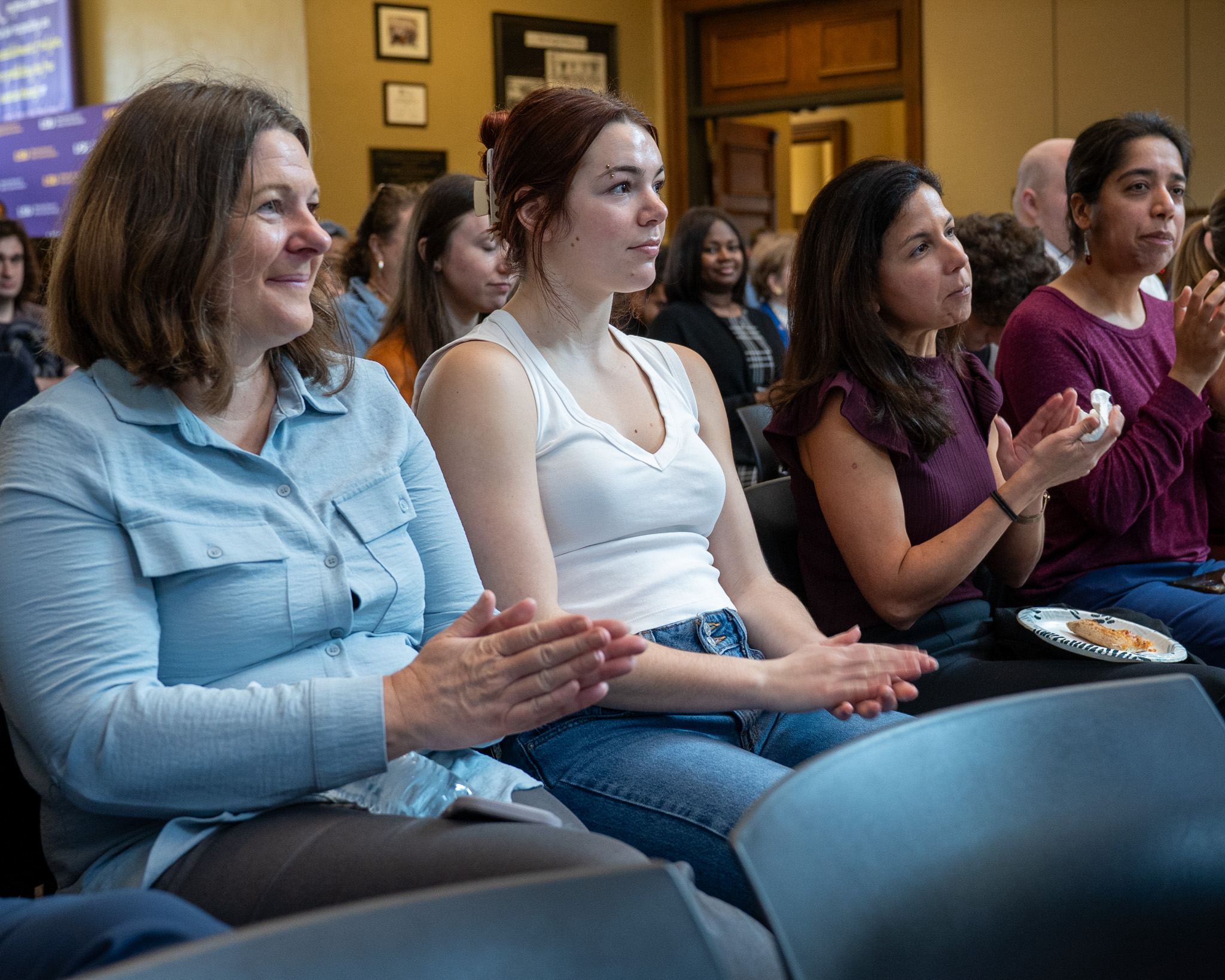 Students attending an event clapping