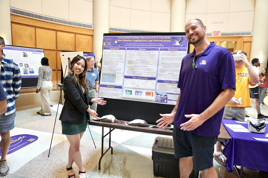 Student and faculty member at research presentation event