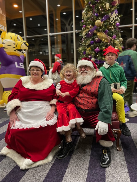 Santa Claus and Mrs. Claus with children