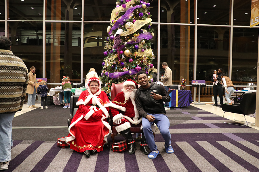 student with Santa and Mrs. Claus