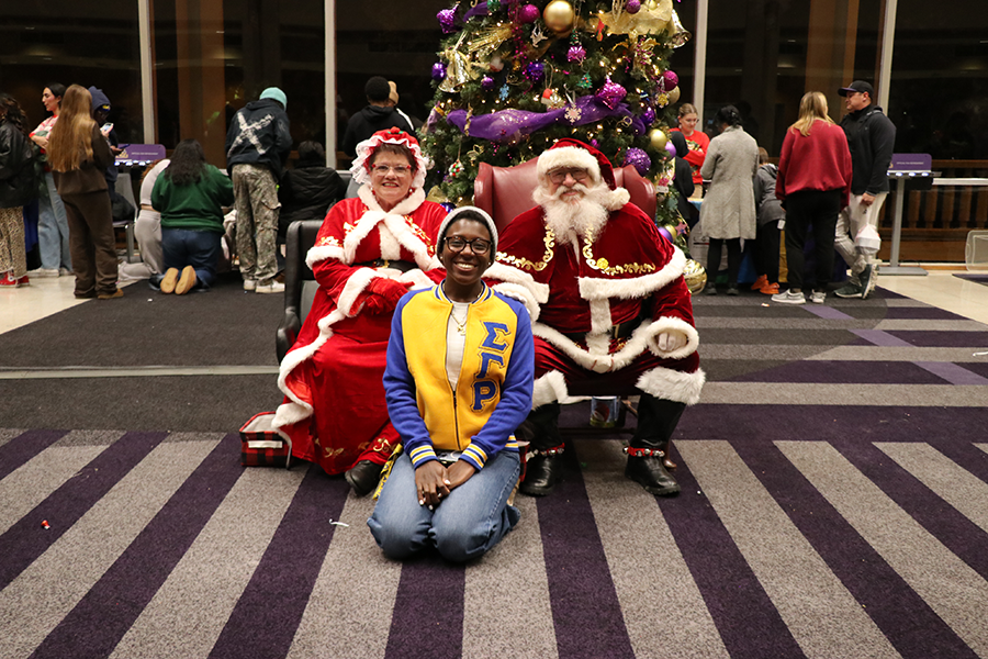 student with Santa and Mrs. Claus